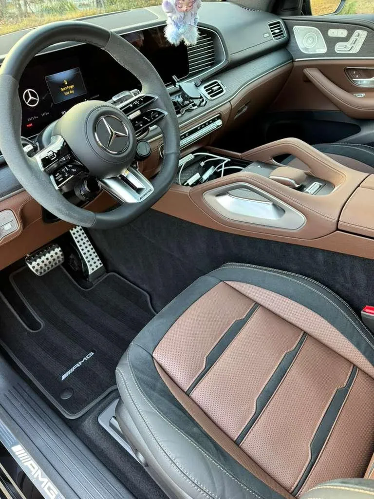 Detailer wiping down a spotless car interior console
