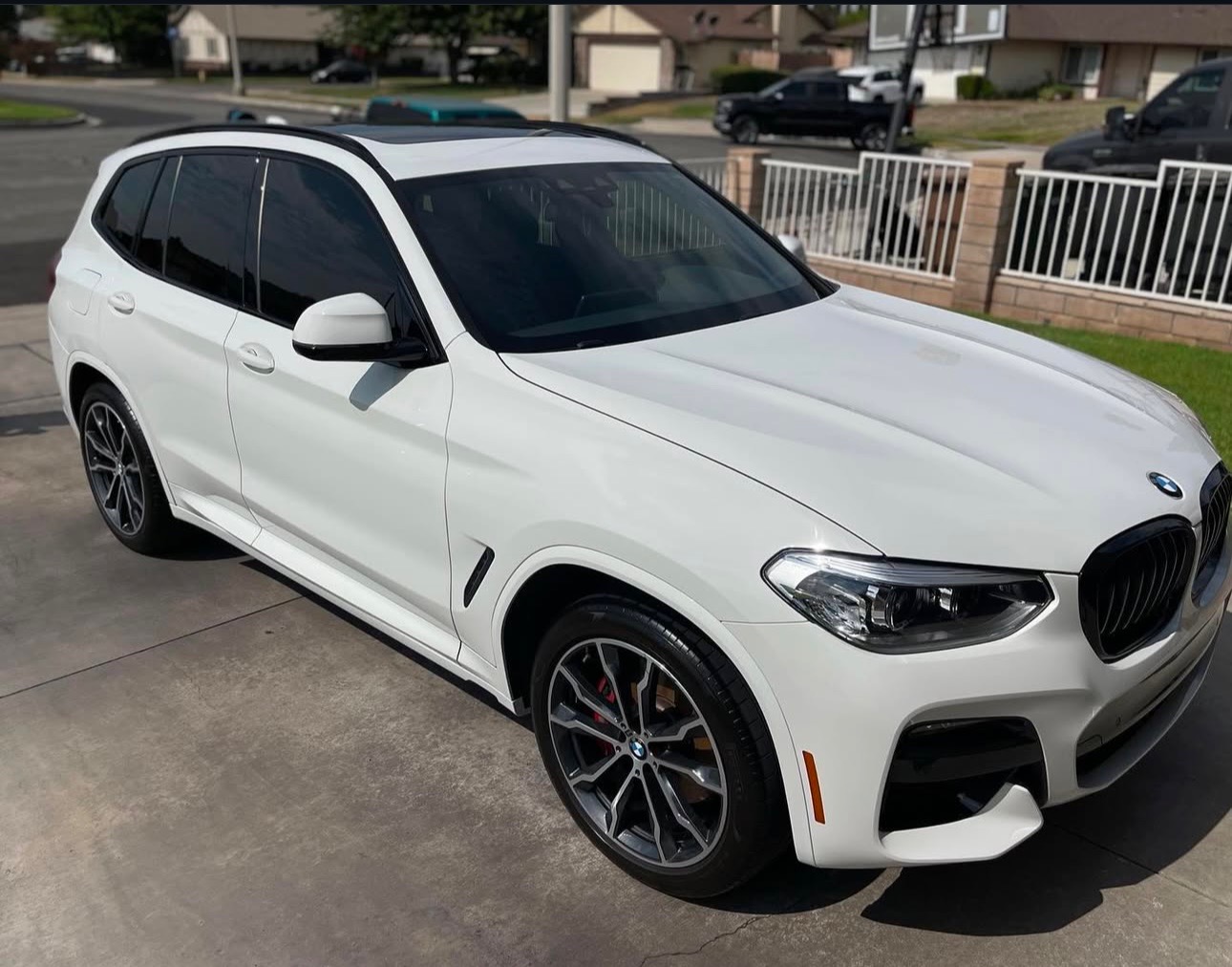 White BMW X3 detailed to a gloss finish in a Los Angeles driveway