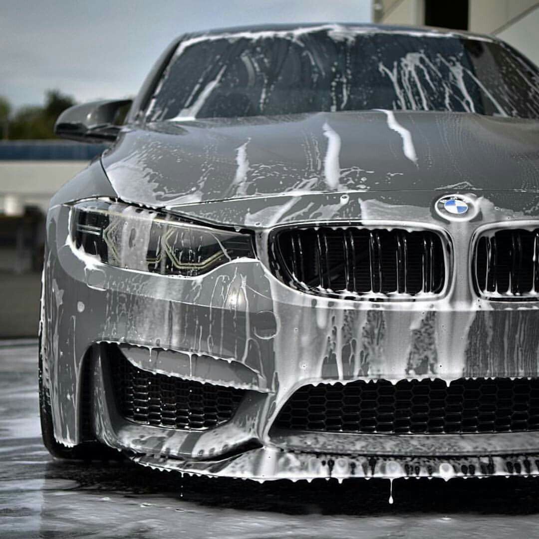BMW M3 covered in thick snow foam during a decontamination wash